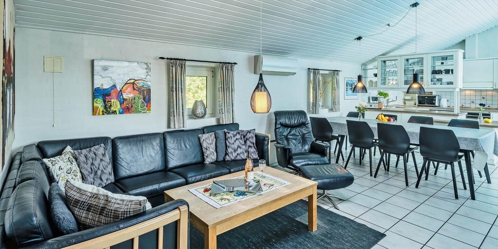 Living and dining area with sofa, dining table, and kitchen.