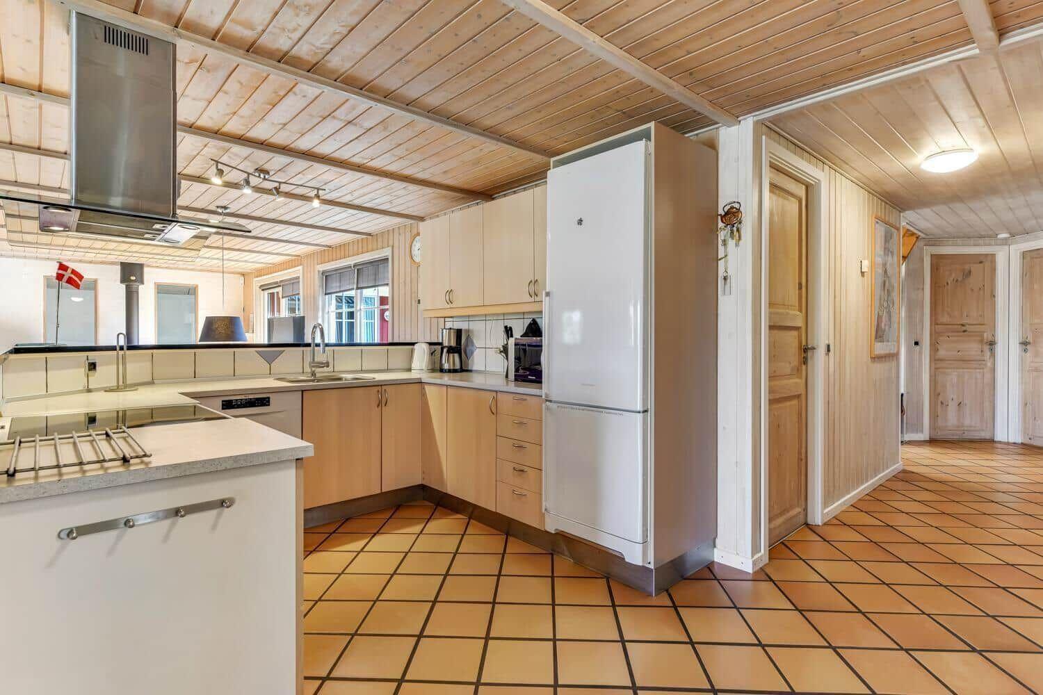 Kitchen with wooden ceiling, refrigerator, and work surface