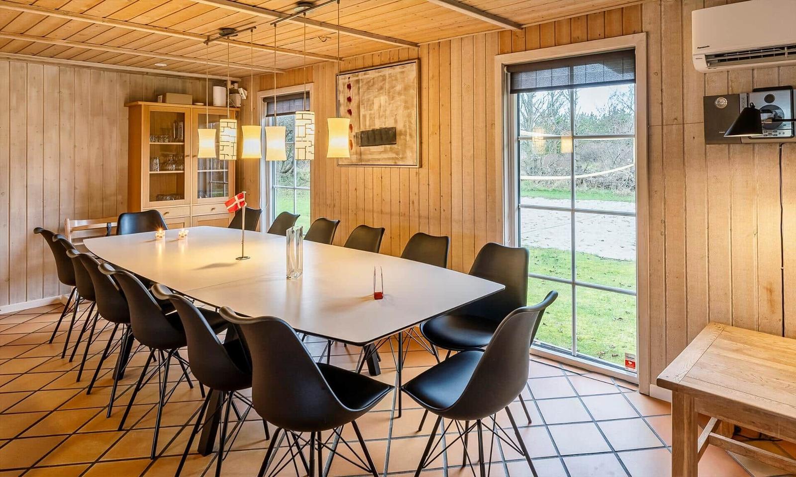Large dining area with table, chairs, and window to the outside.
