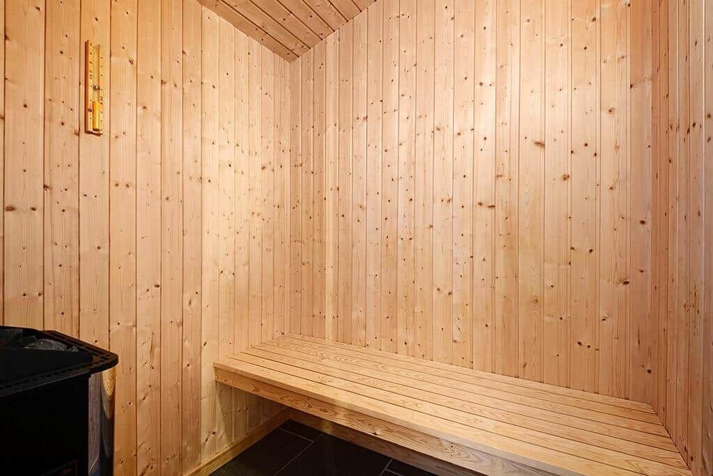 Sauna mit Holzwandverkleidung und Sitzbank.
