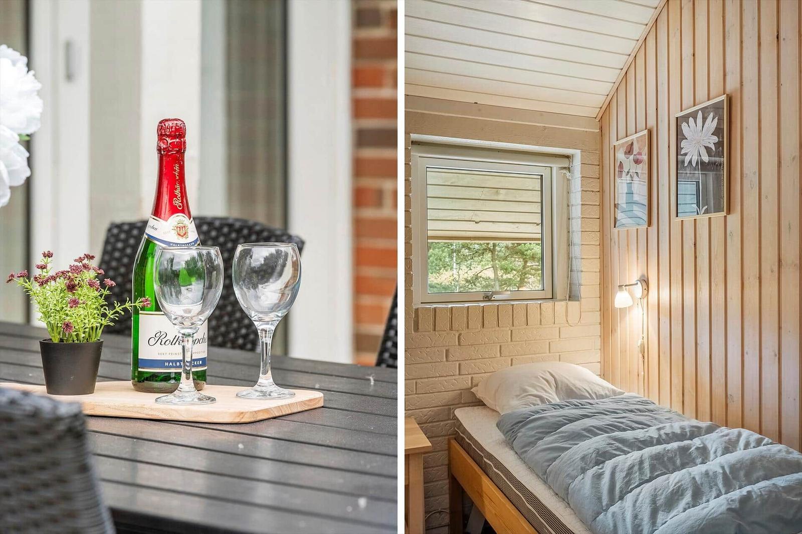 Terrasse mit Flasche und Gläsern. Schlafzimmer mit Bett und Fenster.