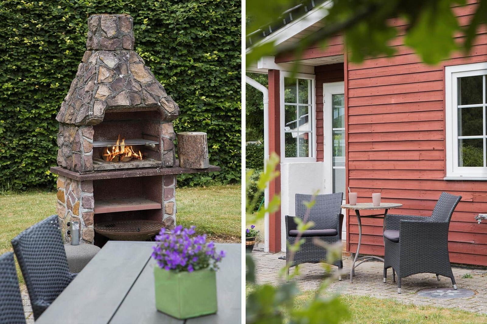 Außenbereich mit Steinofen und Terrasse vor rotem Holzhaus