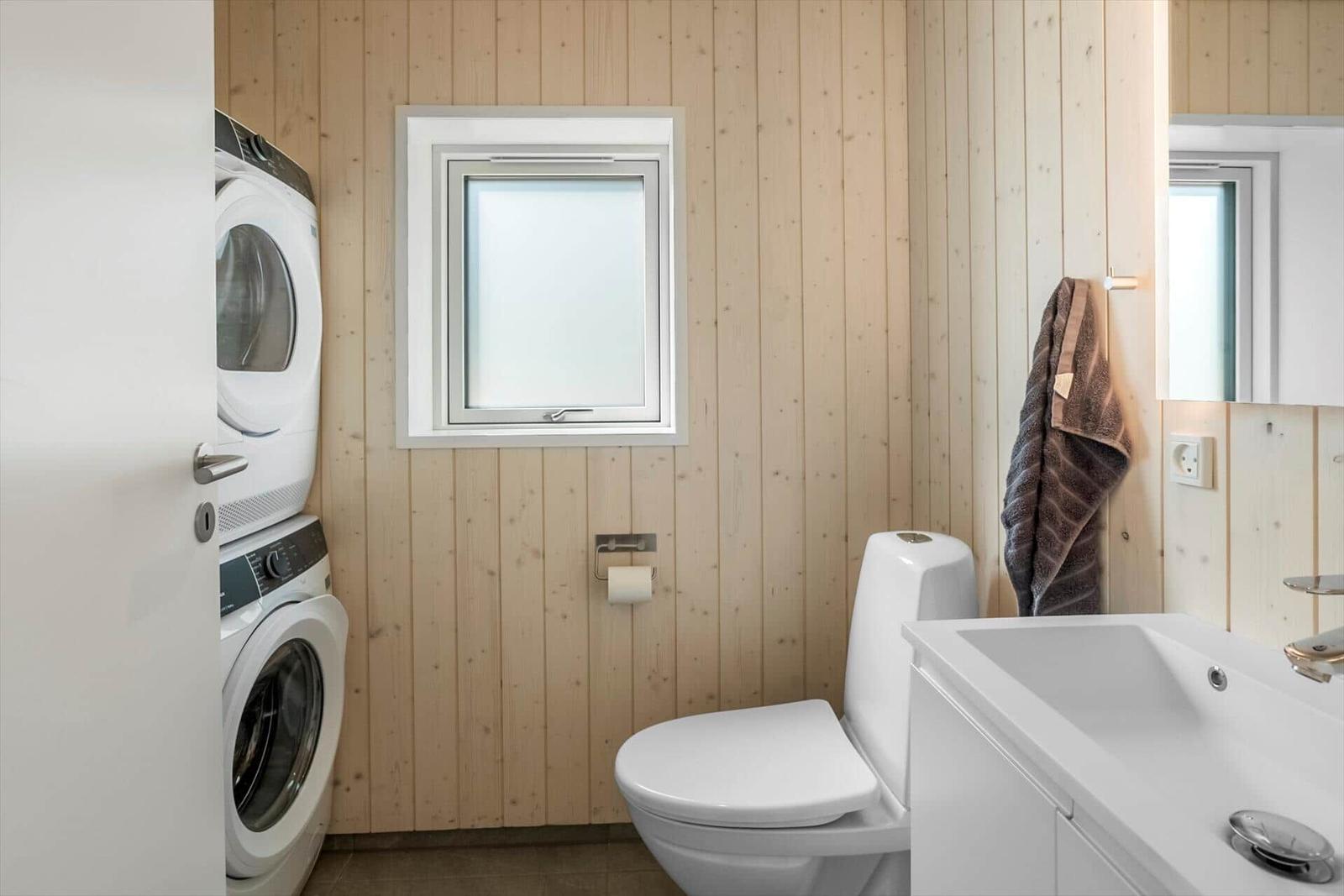 Bathroom with toilet, sink, and washing machine