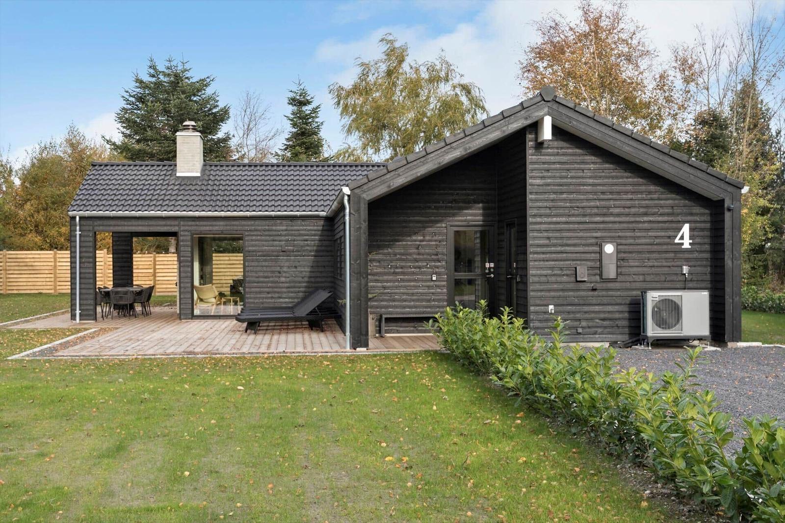 Modern wooden cabin with terrace, garden, and outdoor shower. Number 4.