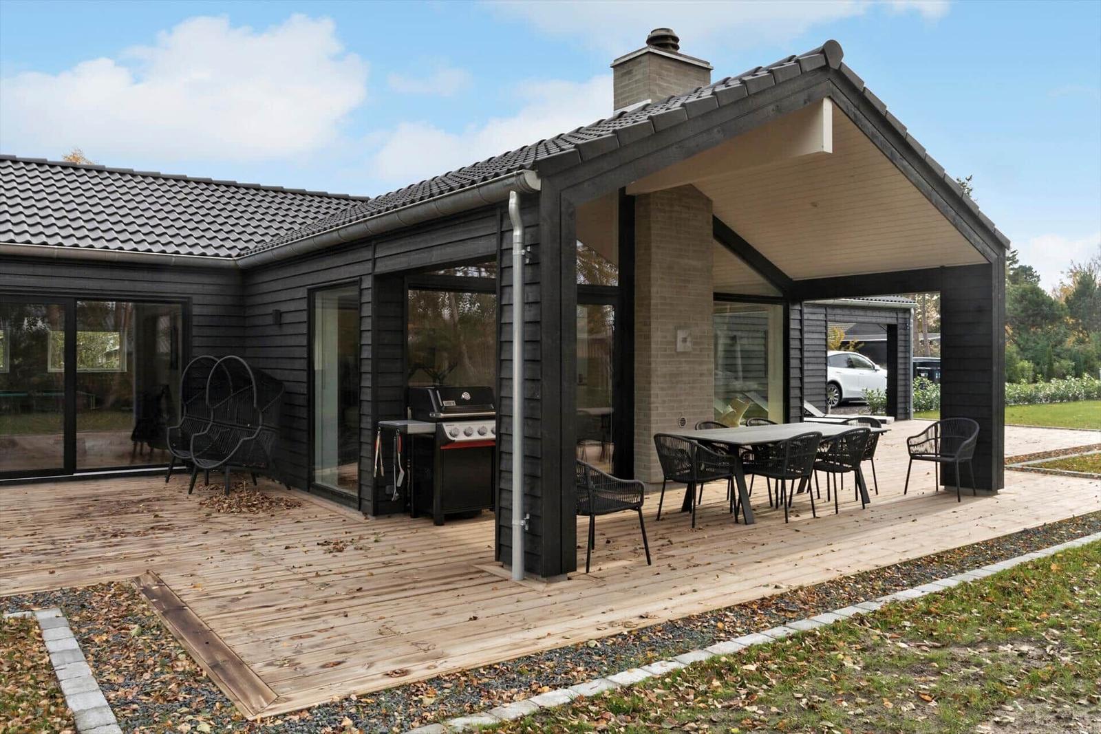 Deck with grill and seating under roof