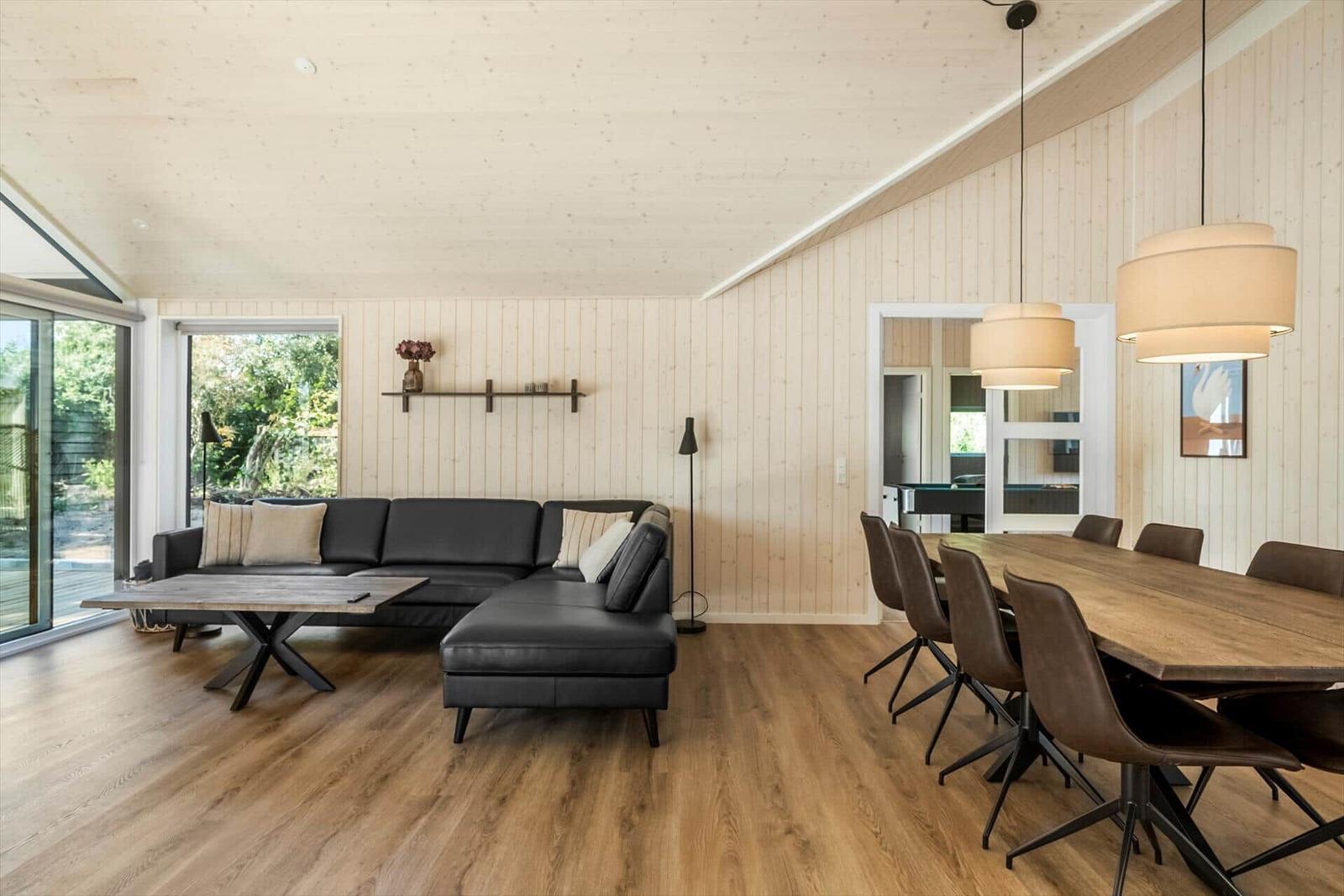 Living and dining area with sofa, dining table, and hardwood floor.