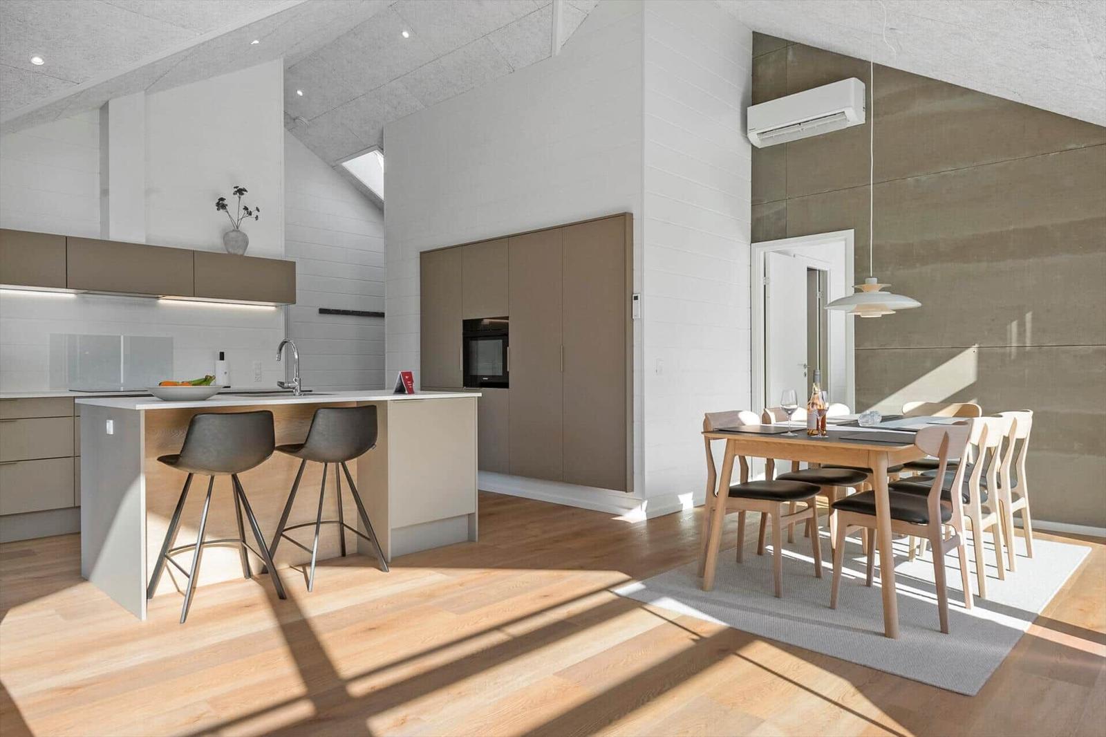 Kitchen with dining area, wooden floor, and modern furnishings.