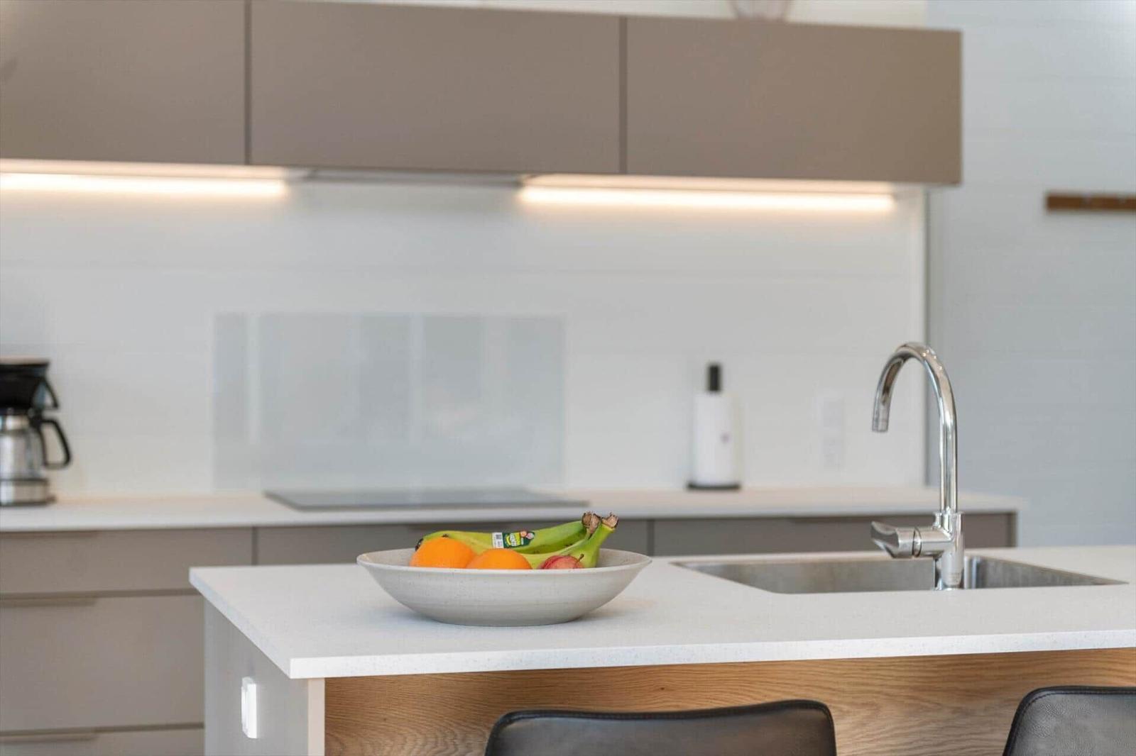 Kitchen with countertop, sink, and fruit bowl.