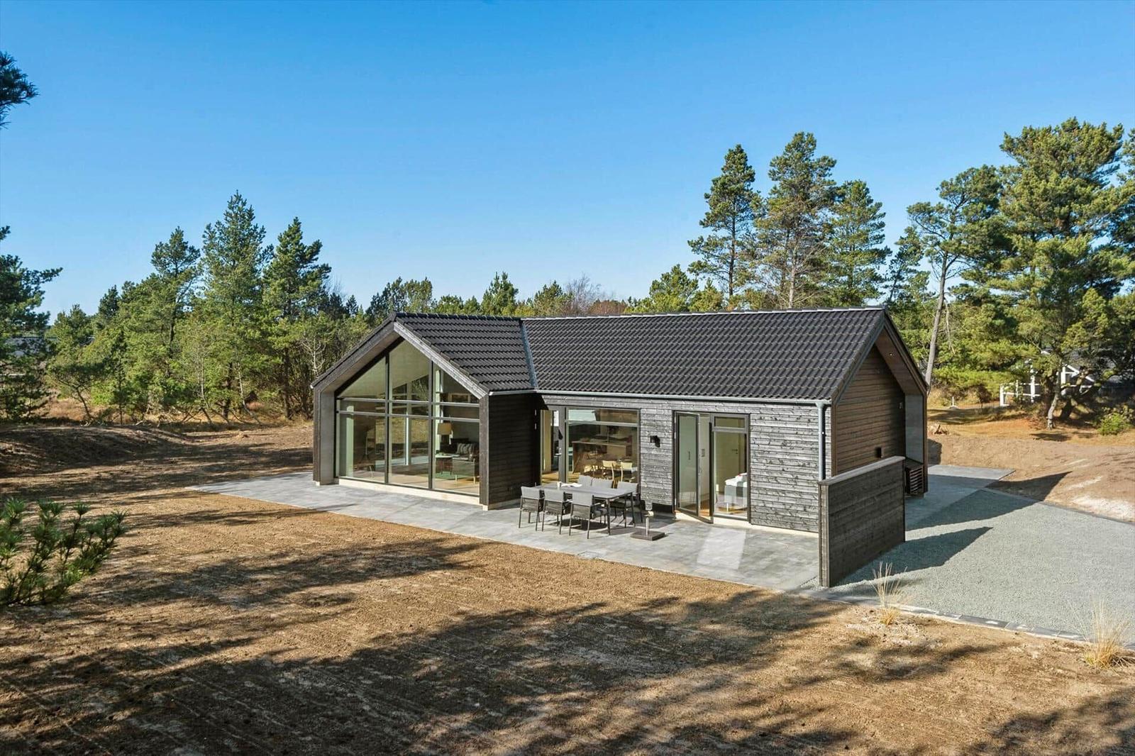Modern villa with large glass area and terrace in the woods