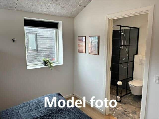 Bedroom with window and adjacent shower