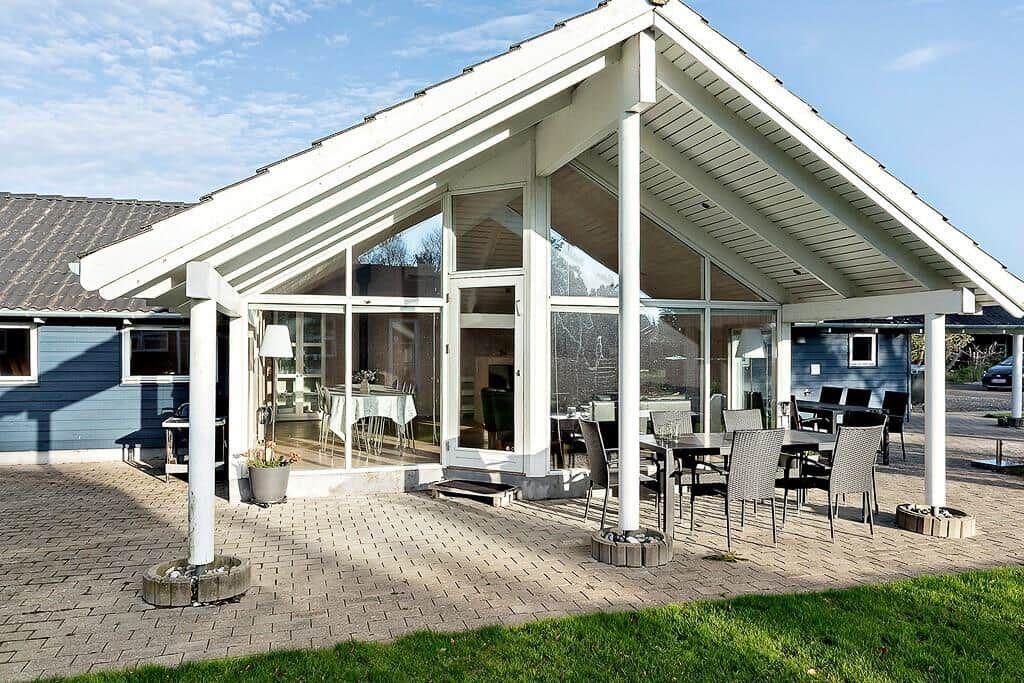 Patio with seating area and glass front to interior
