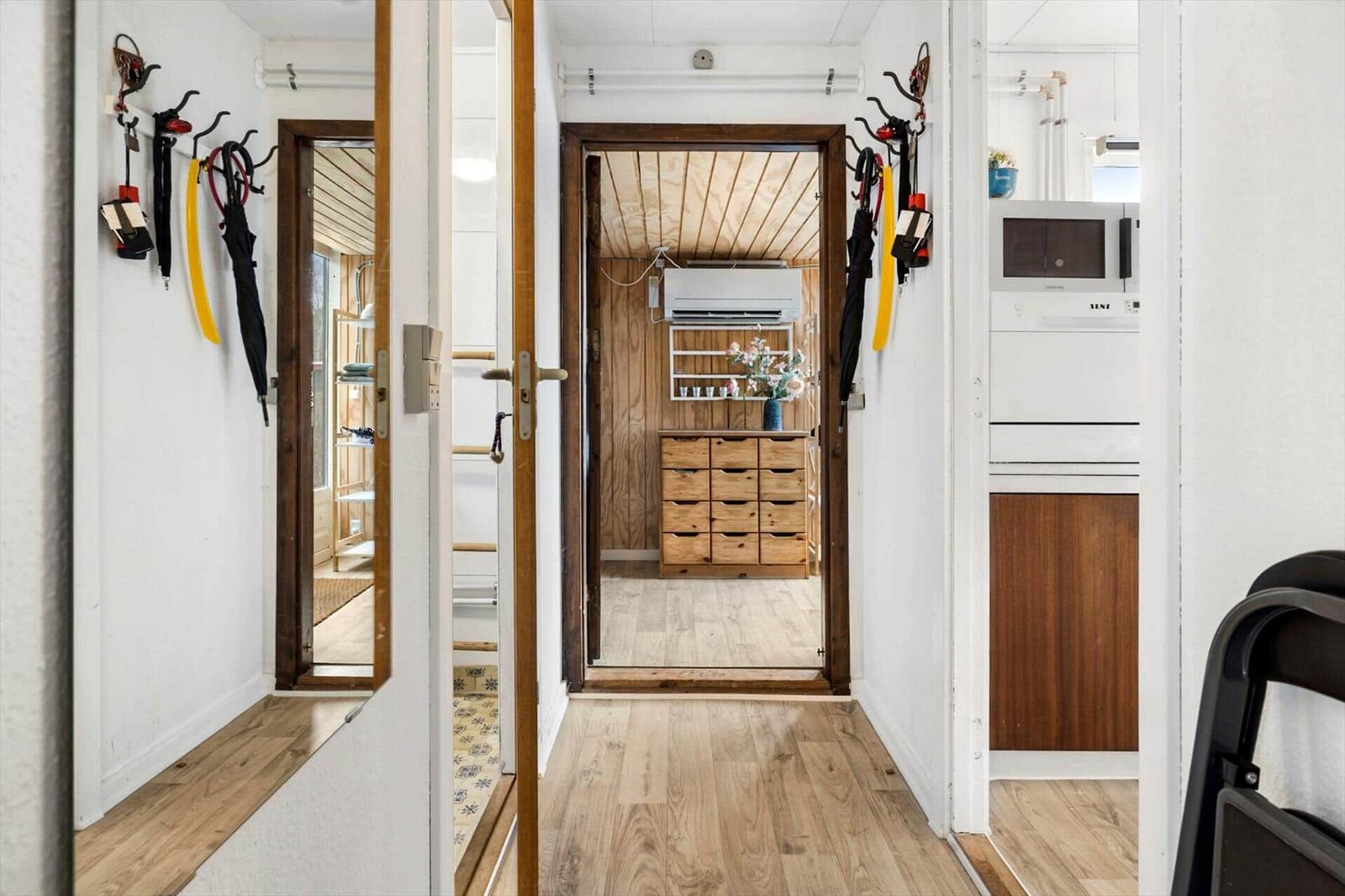 Hausgang mit Holzboden, Garderobe und Küchenbereich