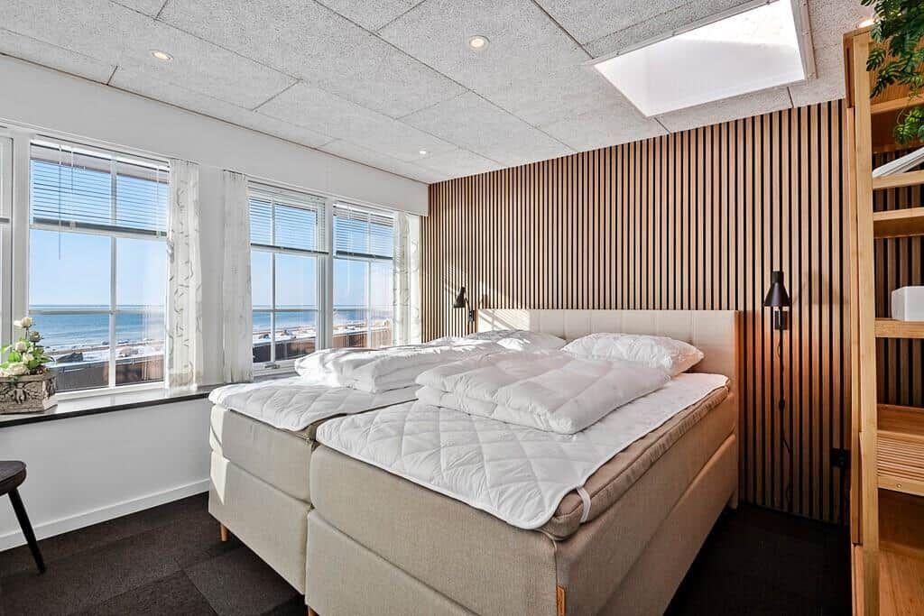 Bedroom with sea view and wooden wall