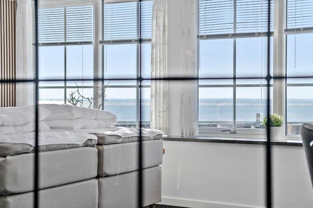 Bedroom with sea view through large windows