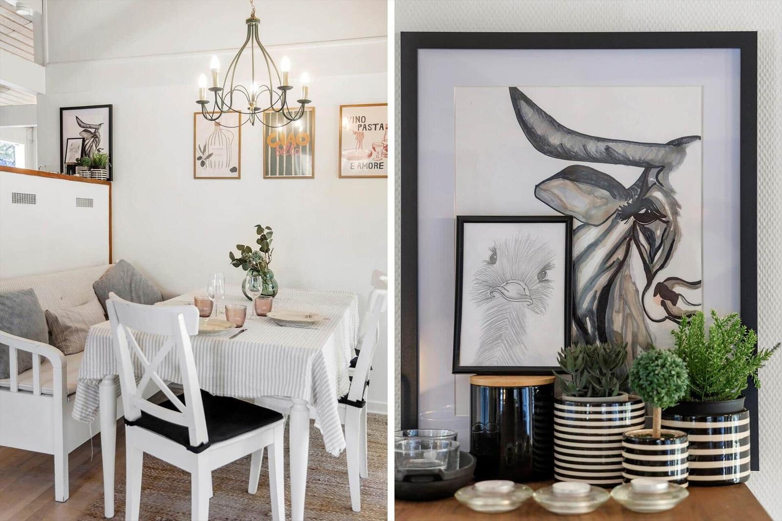 Dining room with table, chairs, and wall art. Adjacent space with artwork and plants.