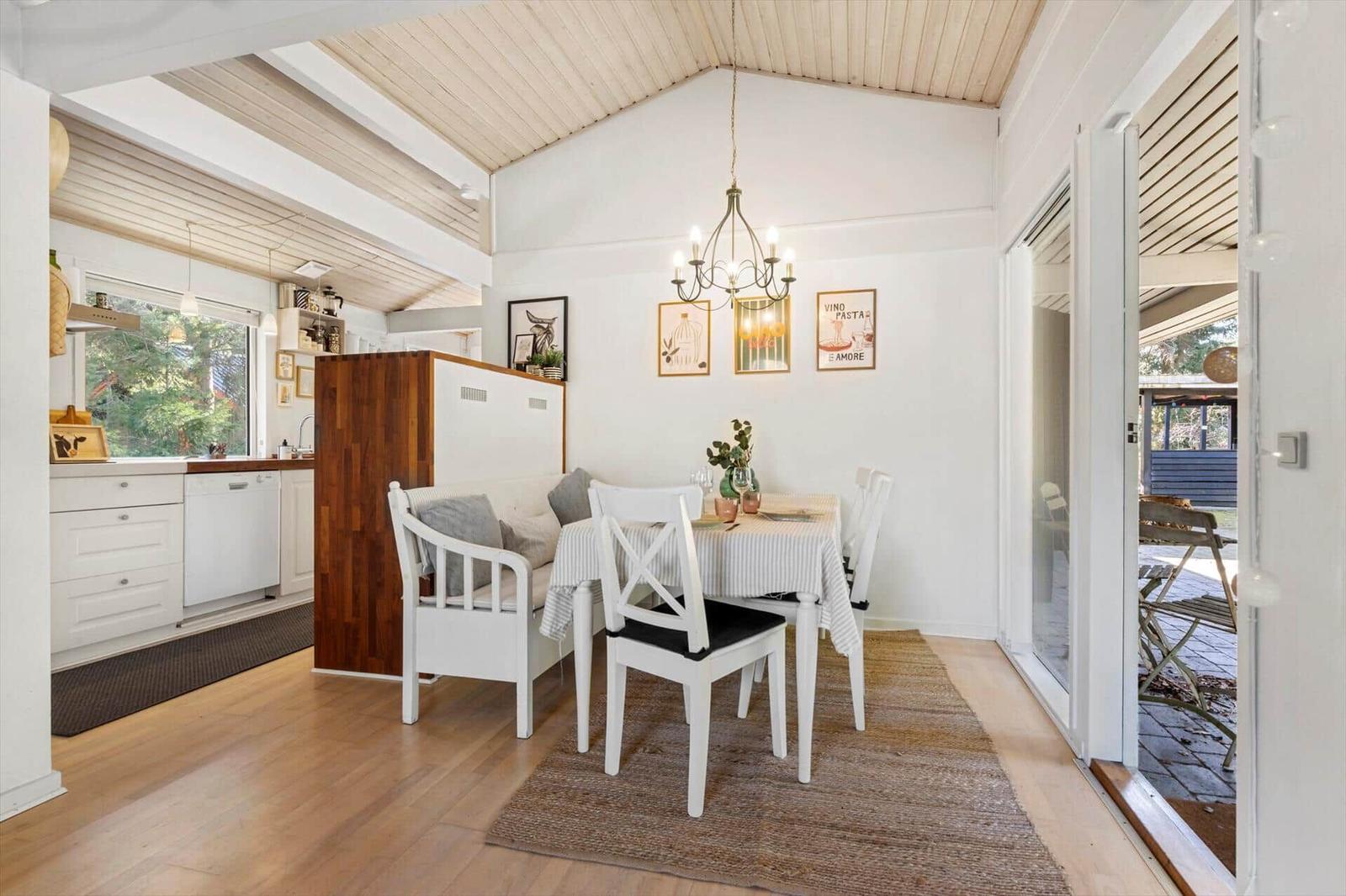 Dining room with table, chairs, and view to the terrace.