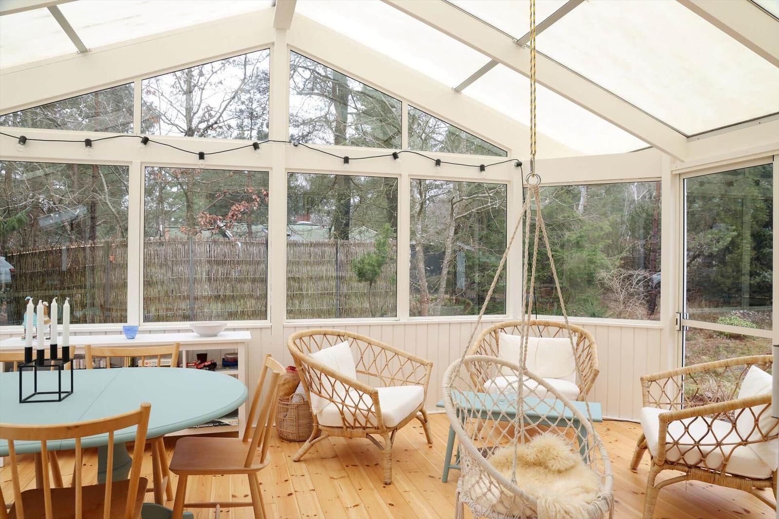 Sunroom with seating and view of the garden.