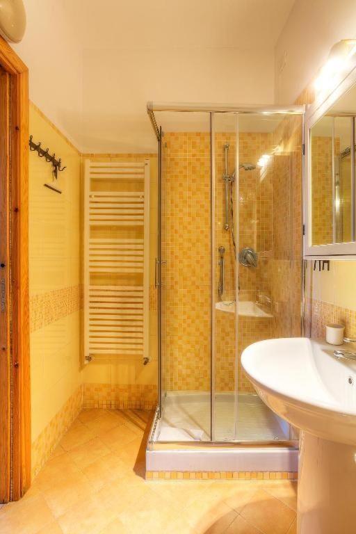 Bathroom with shower, sink, and heater