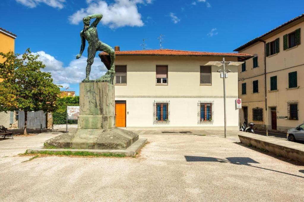 House with orange door and statue in foreground.