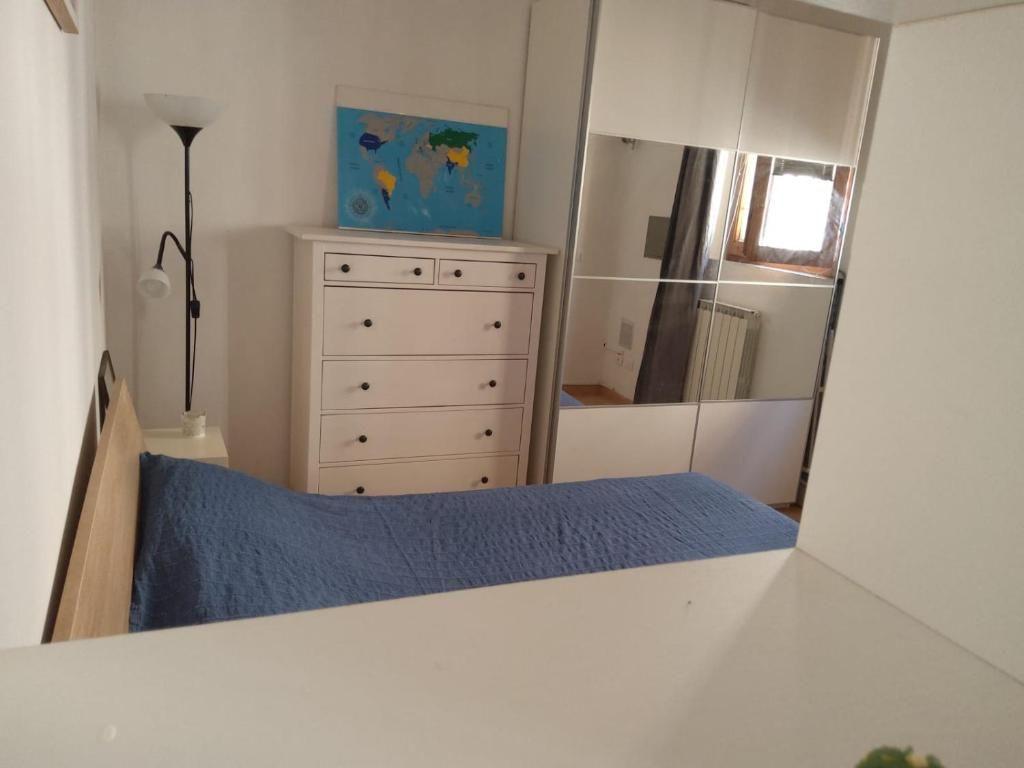 Bedroom with bed, wardrobe, and map on the wall.