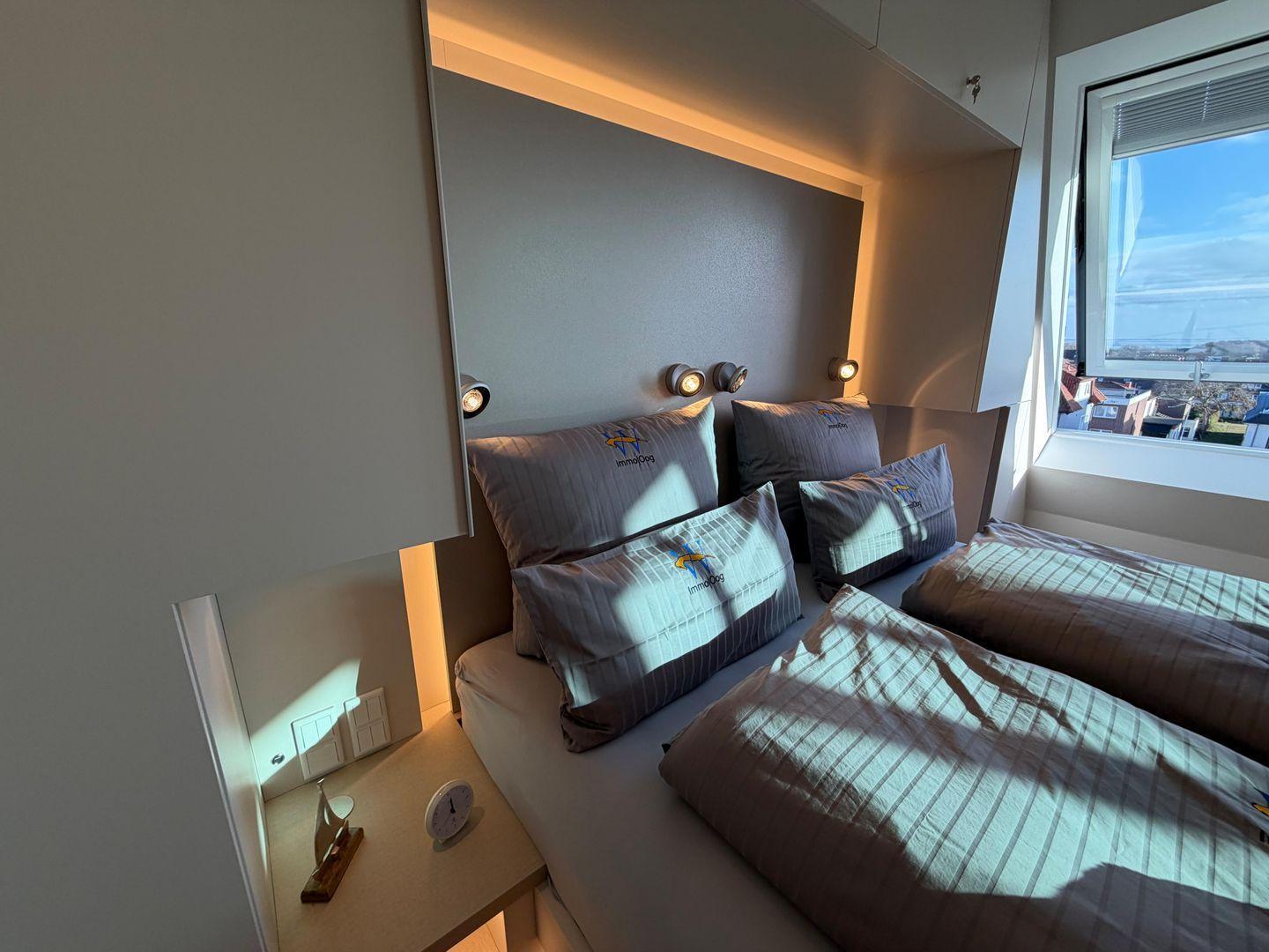 Schlafzimmer mit Doppelbett, Fenster und Nachttisch