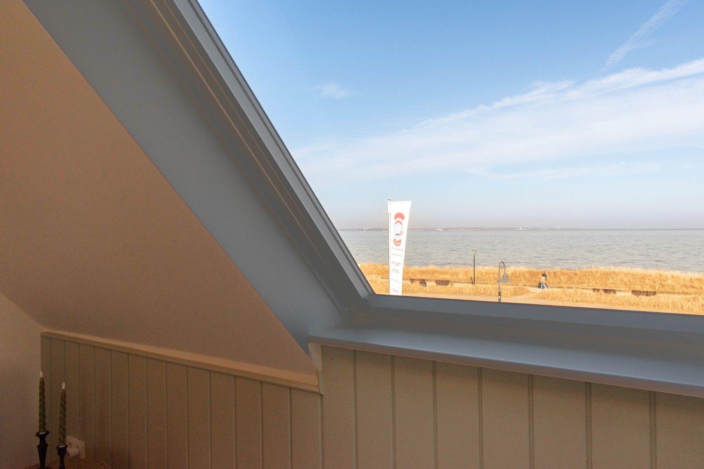 Dachfenster mit Blick auf See und Strand