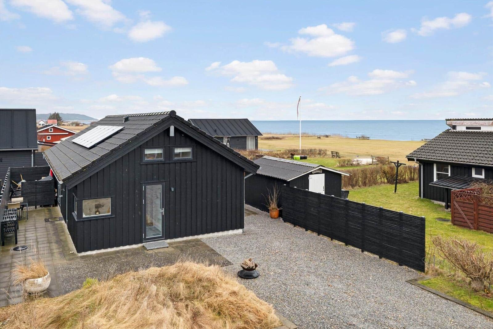 Black holiday home with sea view and garden