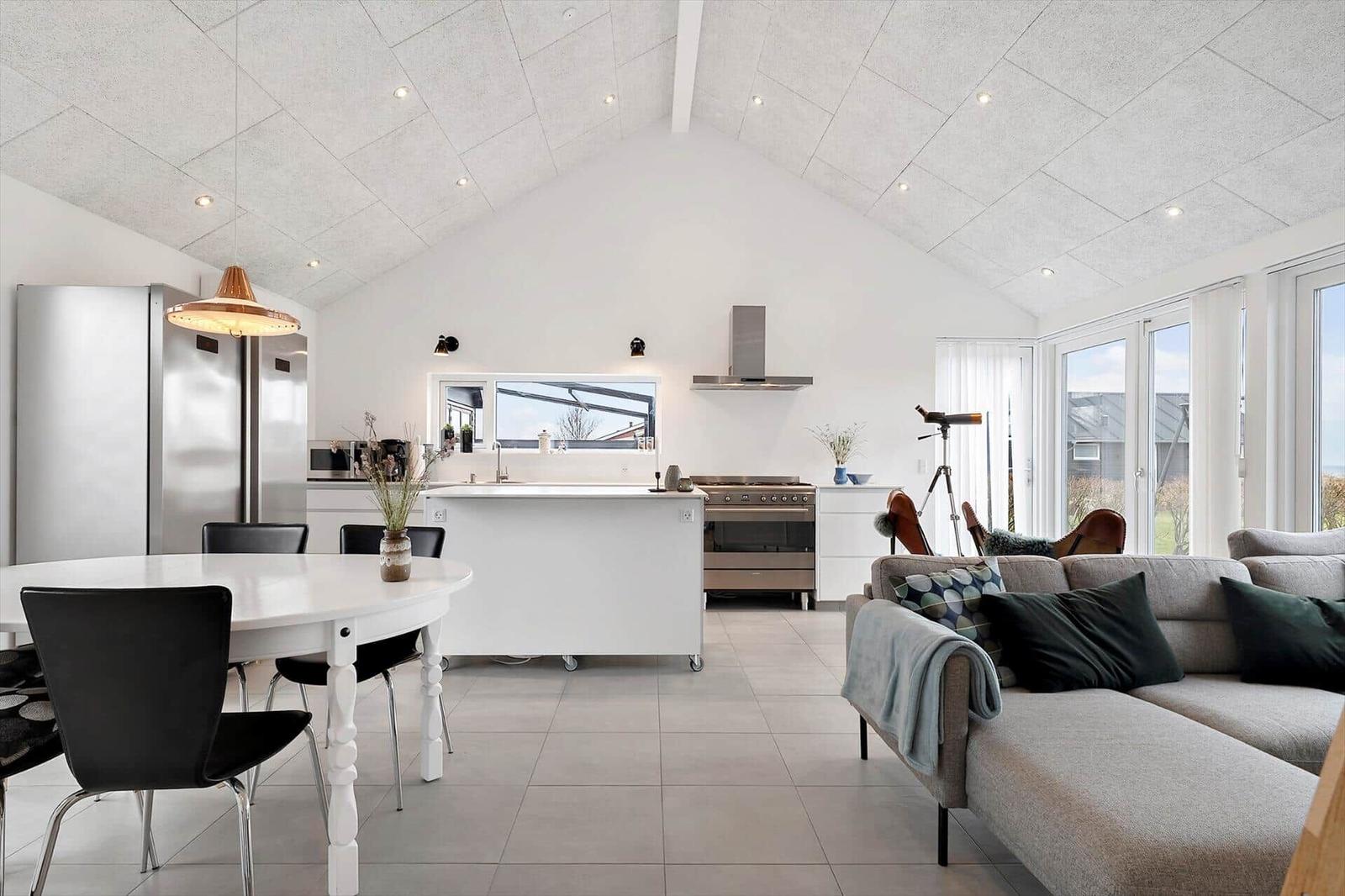 Living and dining area with kitchen island and large window access.