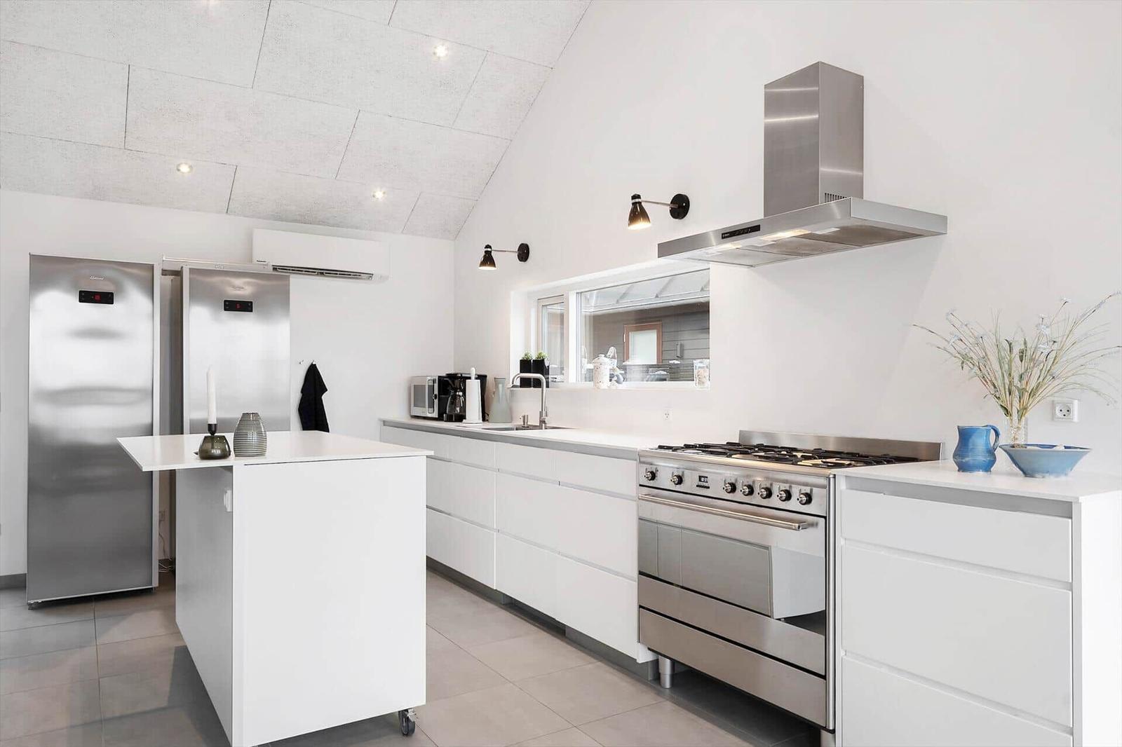 Modern kitchen with white cabinets, stainless steel appliances, and kitchen island.