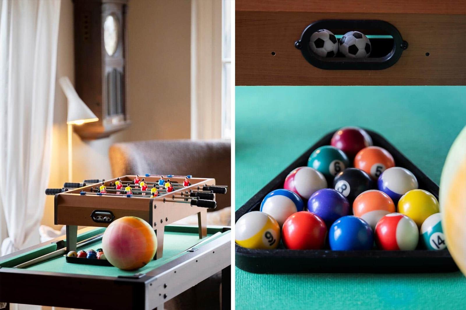 Foosball table and billiard balls on green table