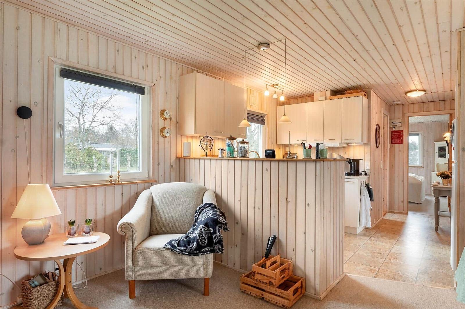 Living area with seating, kitchenette, and view of the outside.