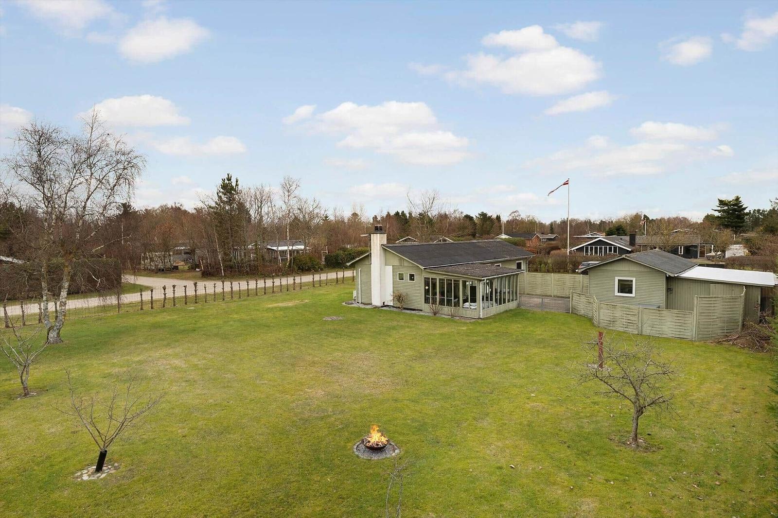House with large garden and fire pit. Danish flag waving.