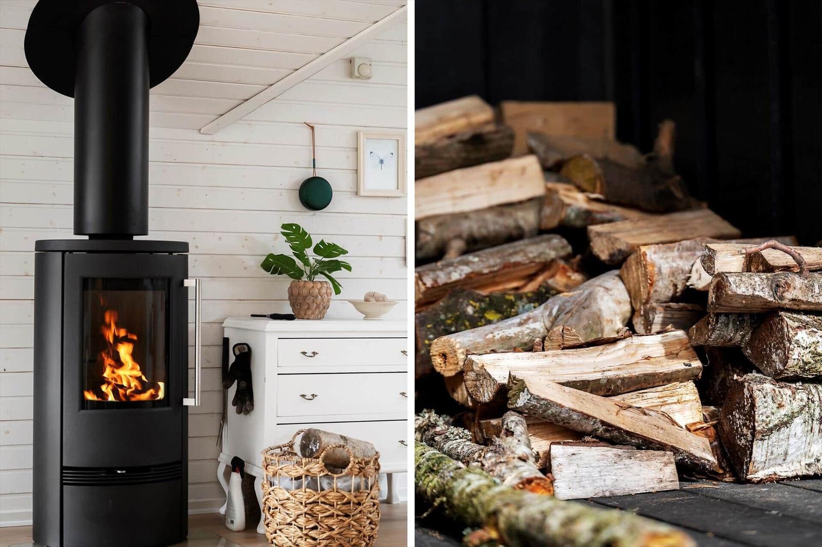 Black wood stove with burning fire next to white dresser and woodpile outside.