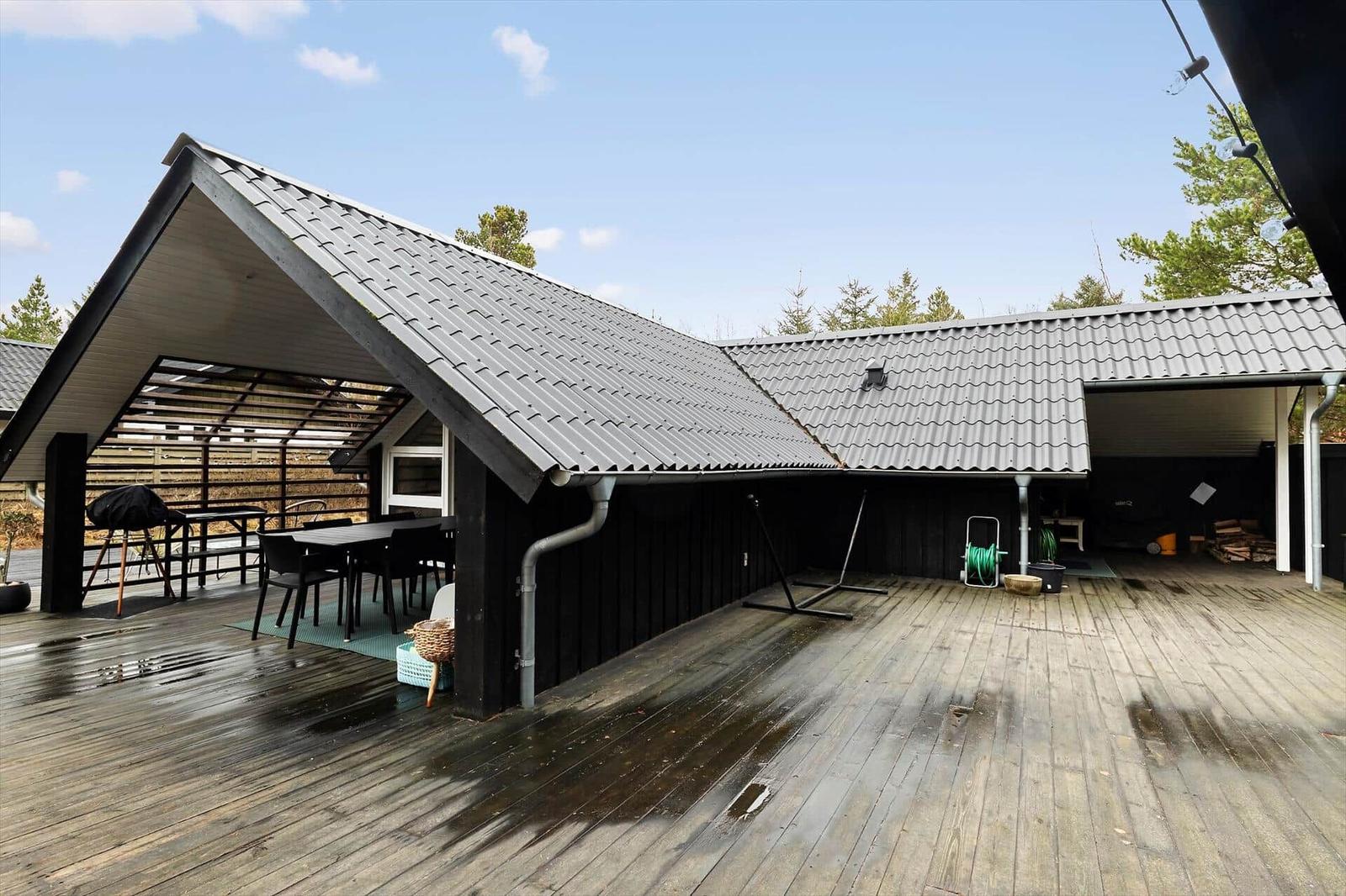 Deck with seating and grill under roof