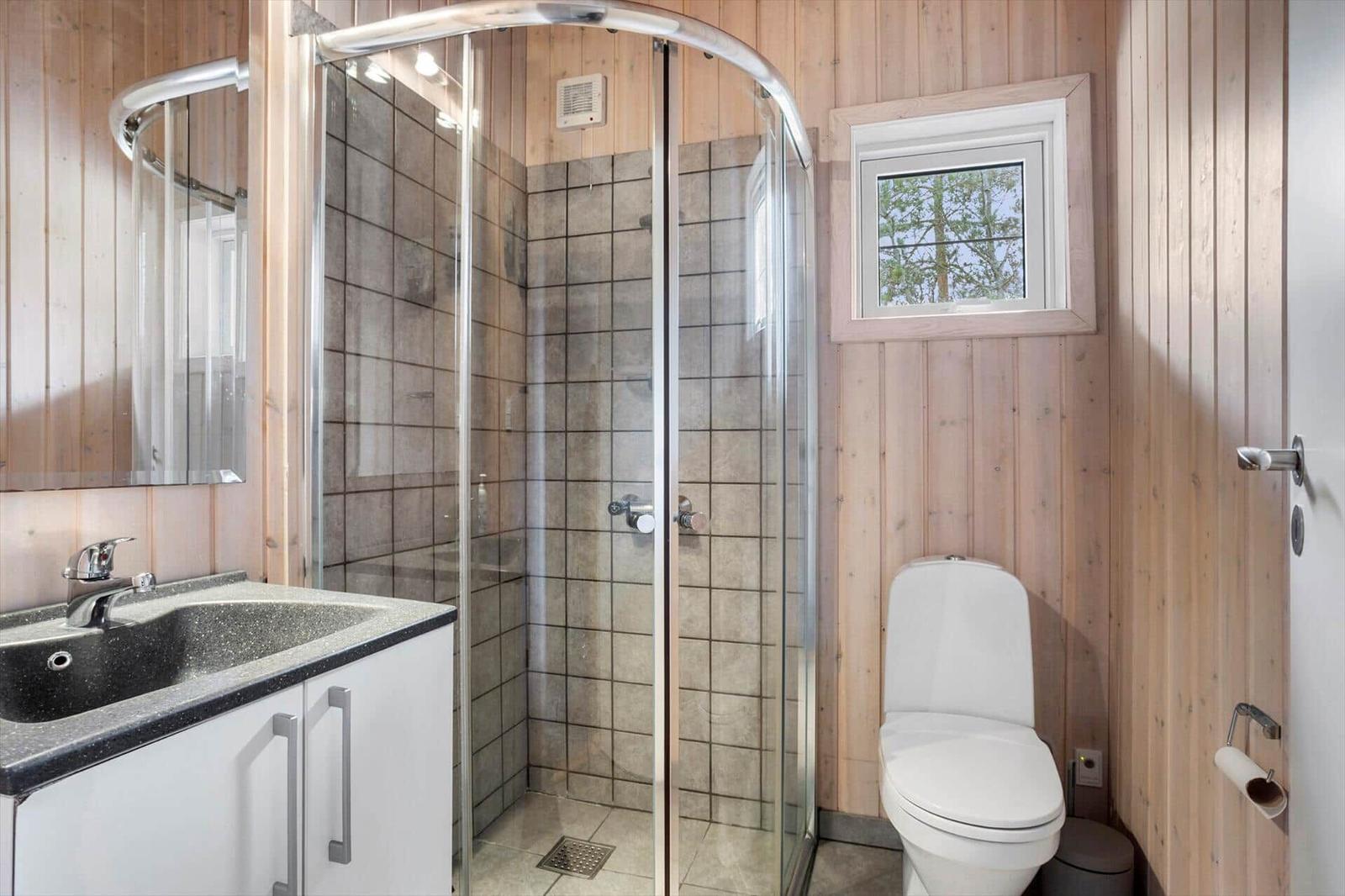 Bathroom with shower, toilet, and sink.