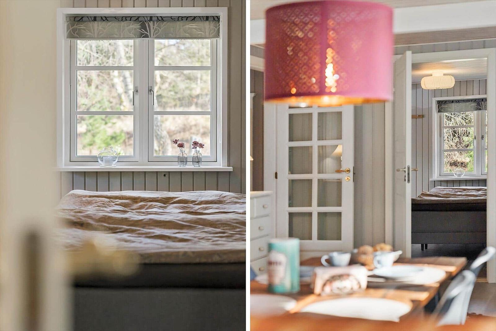 Schlafzimmer mit Fenster und Bett. Essbereich mit Tisch, Stühlen und rosa Lampe.