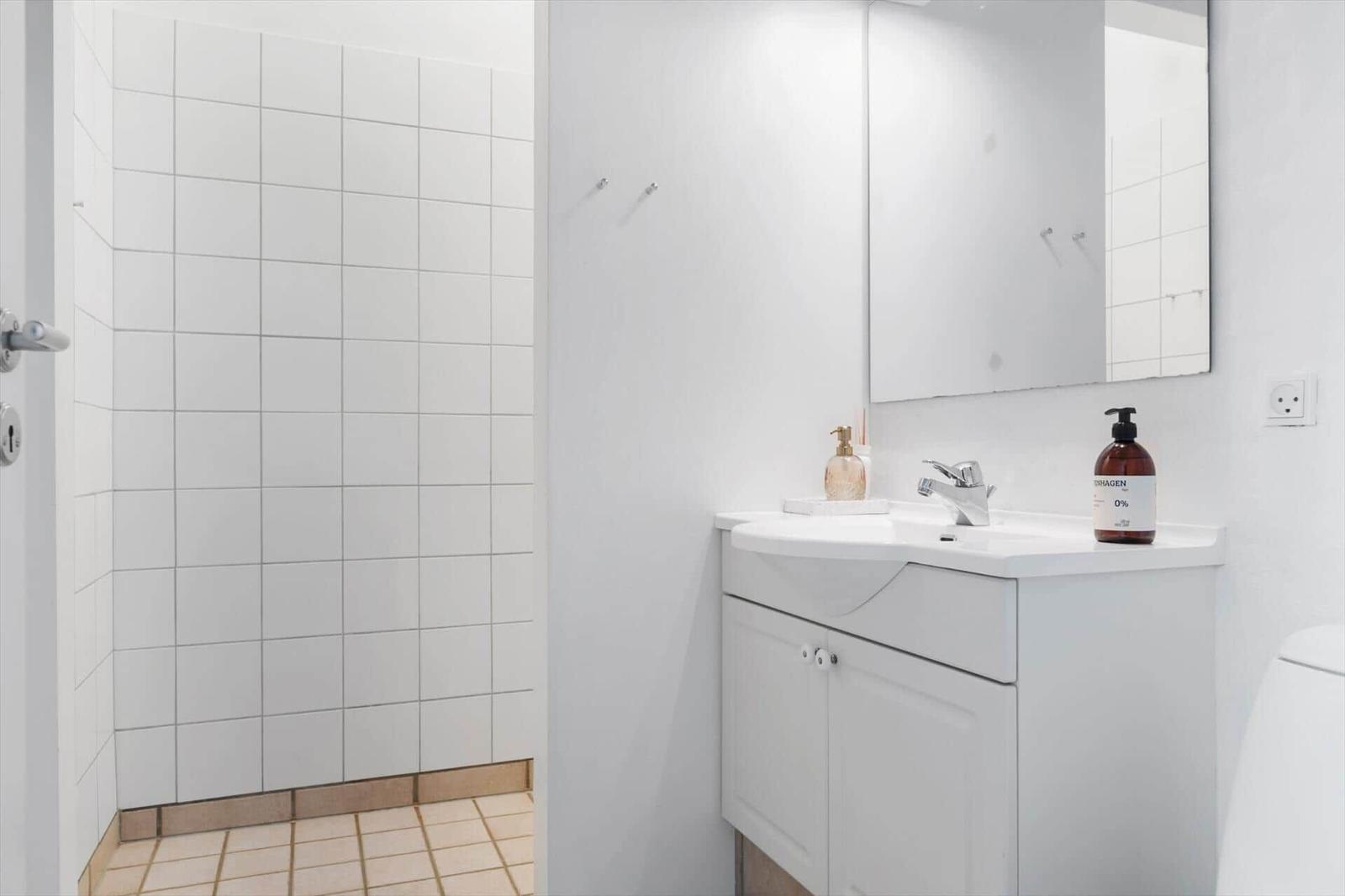 Bathroom with sink, mirror, and shower