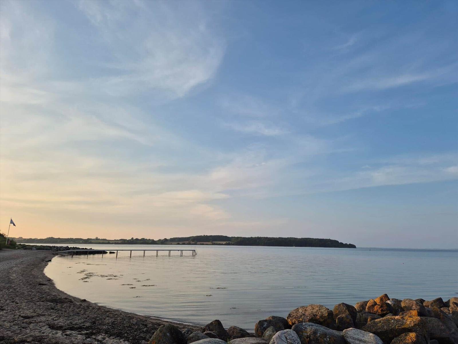 Beach with rocks and marina in the background