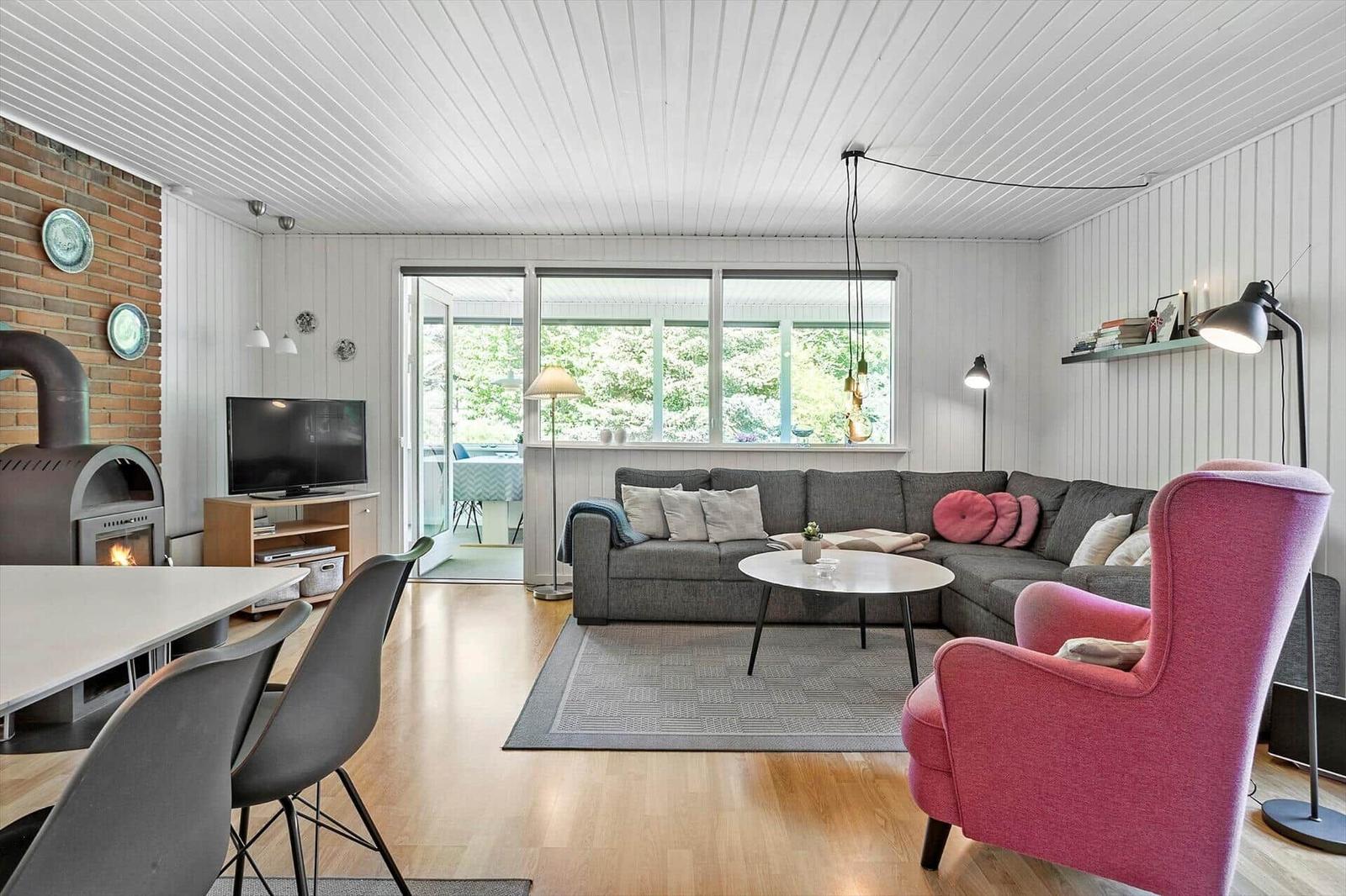 Living room with sofa, dining table, and fireplace