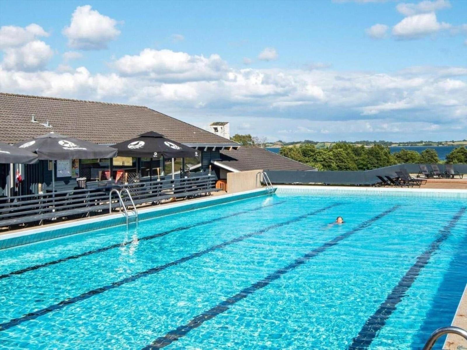 Swimming pool with view of water and landscape