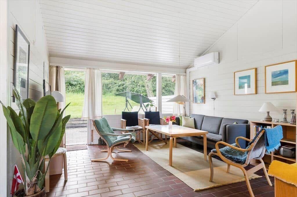 Living room with sofa, chairs, and view of garden