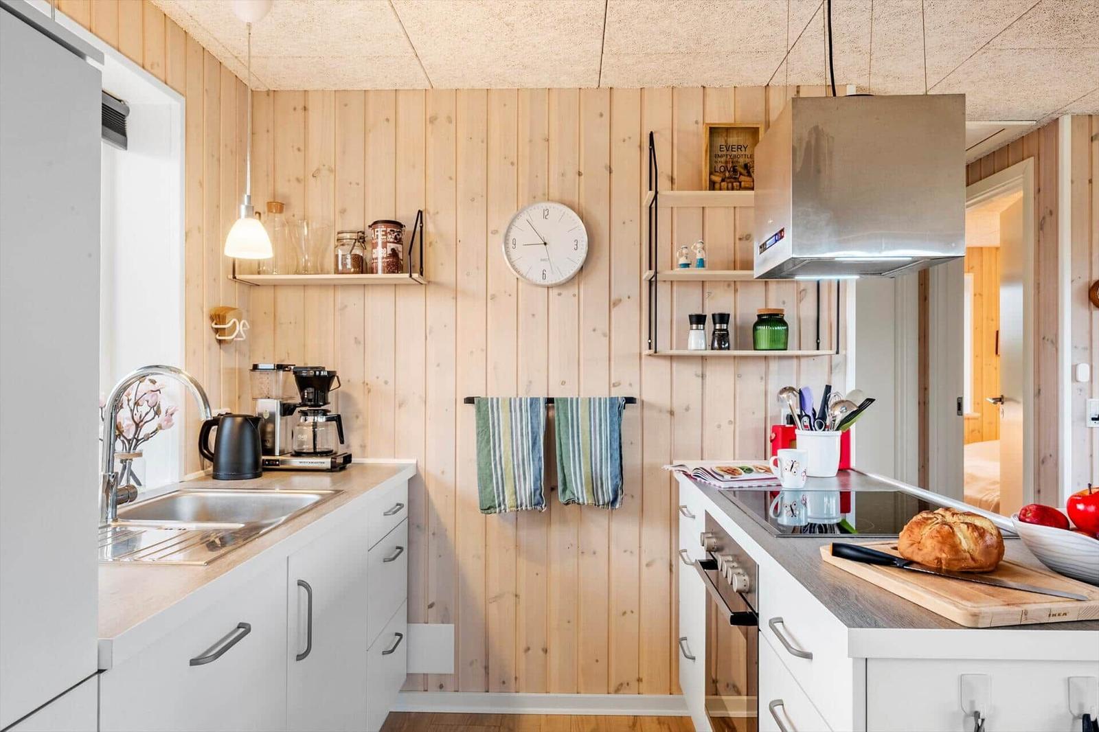 Kitchen with wooden walls, countertops, and kitchen appliances.