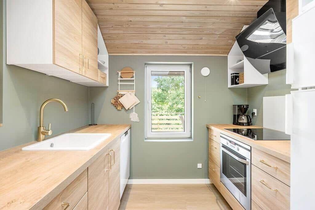 Kitchen with wooden surfaces, window, and modern equipment.