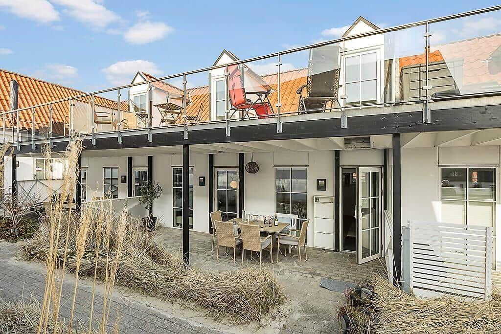 Terrace with table and chairs. Upper level with balcony and lounge chairs.