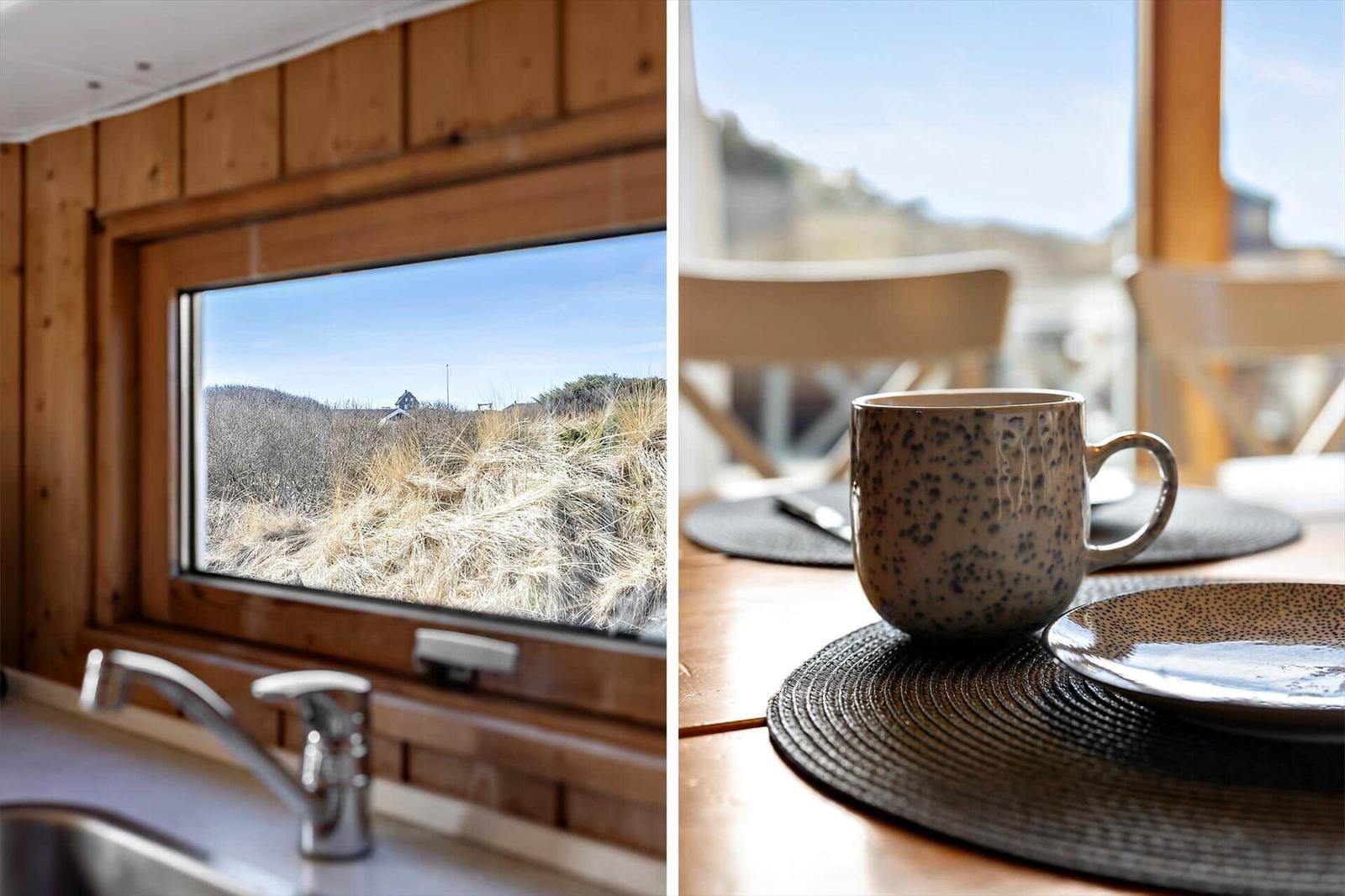 Kitchen with dune view. Table with cup and plate.