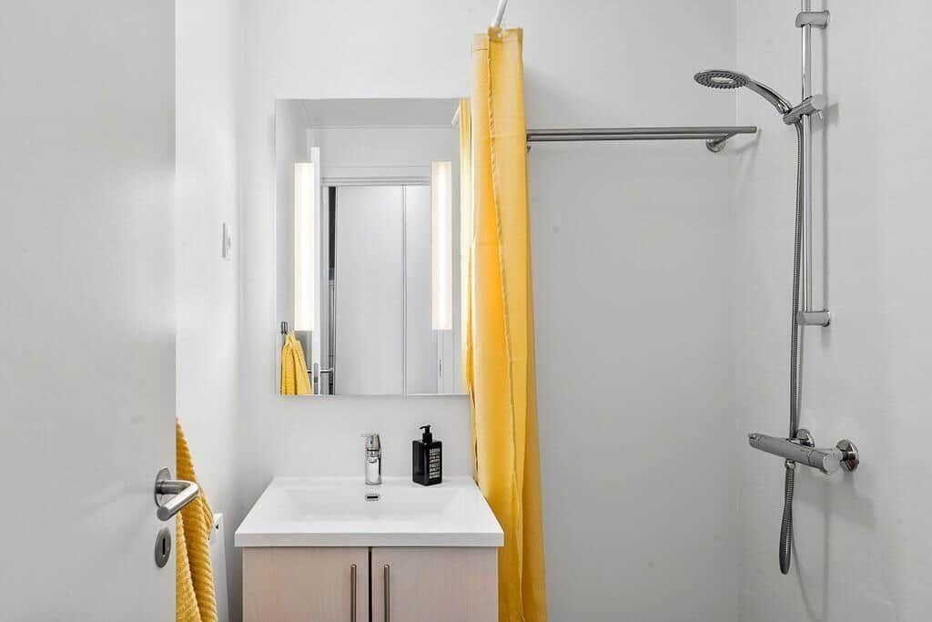Bathroom with shower, sink, and mirror
