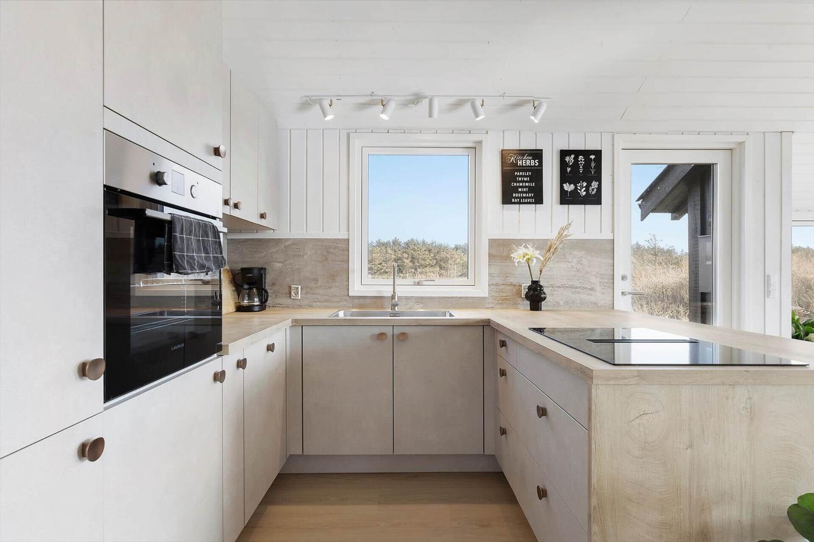 Modern kitchen with integrated oven and kitchen island.
