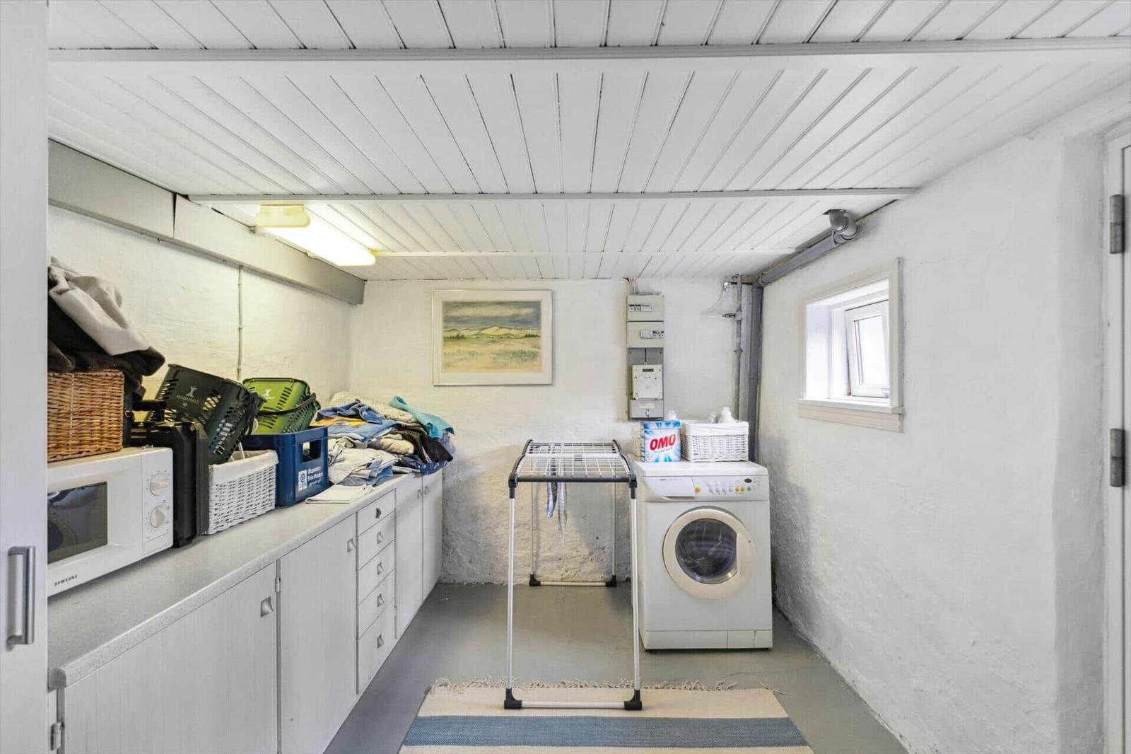 Room with washing machine, dryer, and kitchen counter.