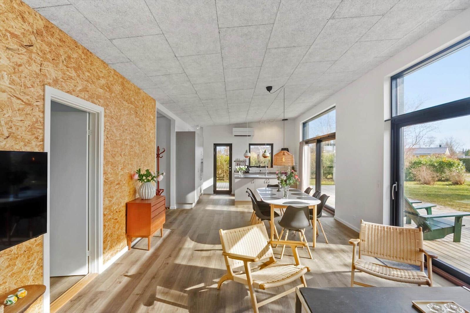 Living area with dining space, TV, and large window to terrace.