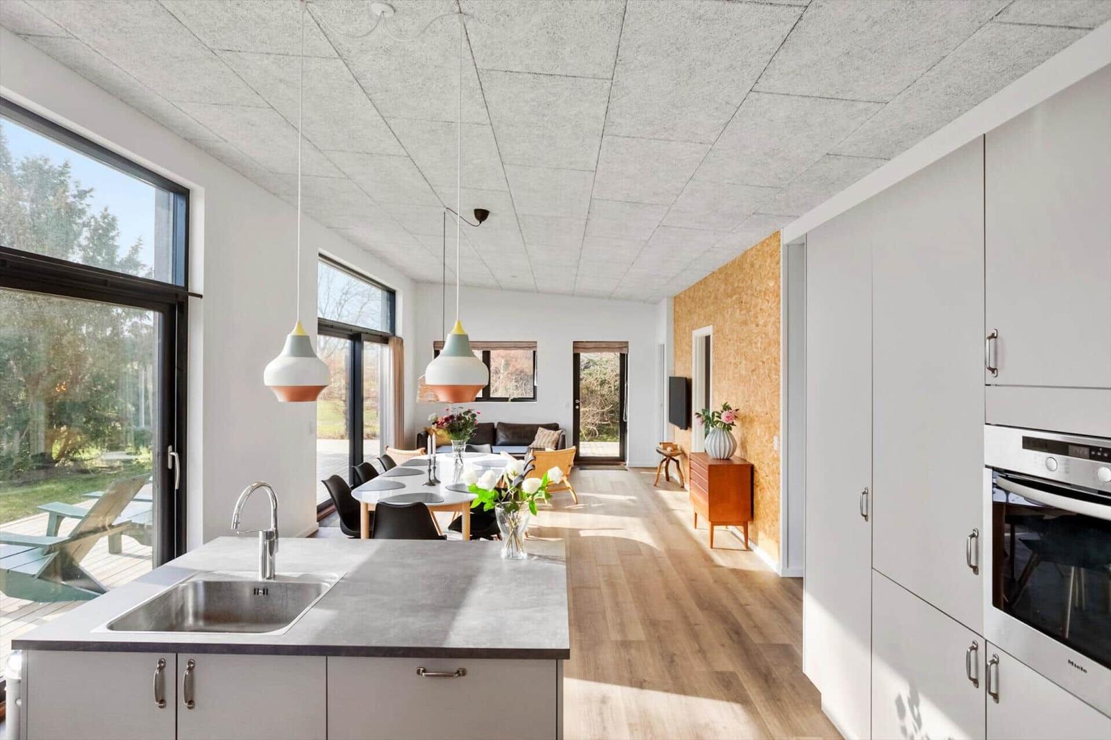 Kitchen with dining area and living room in background